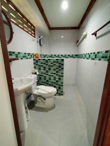 a bathroom with a toilet and a sink at Palmsuay Resort in Ban Dong Klang +15 photos