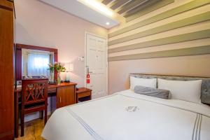 Postel nebo postele na pokoji v ubytování Ace Hotel Ben Thanh