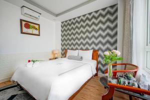 Postel nebo postele na pokoji v ubytování Ace Hotel Ben Thanh