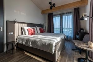 Postel nebo postele na pokoji v ubytování Fruitpark Hotel & Spa