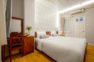 Postel nebo postele na pokoji v ubytování Ace Hotel Ben Thanh
