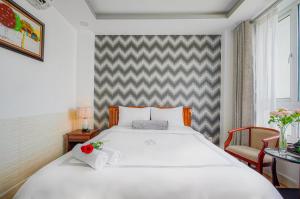 Postel nebo postele na pokoji v ubytování Ace Hotel Ben Thanh
