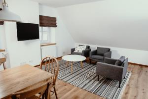 a living room with two chairs and a table at Hotel Schierlinger Bräustüberl in Schierling