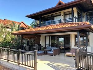 a house with a balcony and a patio at Villa with a view in Ballito