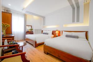 Postel nebo postele na pokoji v ubytování Ace Hotel Ben Thanh
