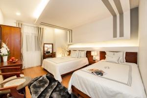 Postel nebo postele na pokoji v ubytování Ace Hotel Ben Thanh