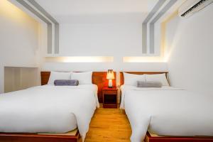 Postel nebo postele na pokoji v ubytování Ace Hotel Ben Thanh