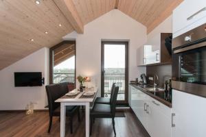 a kitchen and dining room with a table and chairs at Ferienwohnung Kayserlay in Hürtgenwald