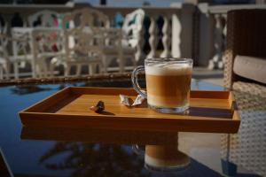 a glass of beer sitting on a wooden tray at Anna Panzió & Wellness Siófok in Siófok