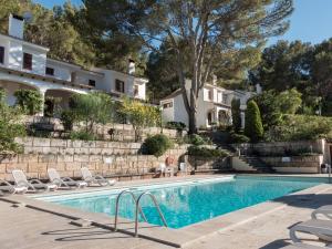 a swimming pool in front of a house at Villa Cala San Vicente - Can Botana 6 in Cala de Sant Vicent