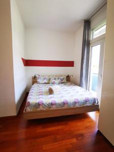 a bedroom with a bed in a room with a window at Apartment BELLA VISTA in Bolzano