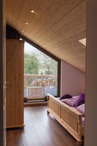 a bedroom with a bed and a large window at Schöne moderne Ferienwohnung-Balkon-Fahrradparkplatz-Wallbox in Hürtgenwald