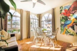 a dining room with a table and chairs and windows at apartamento en Benalmadena in Benalmádena