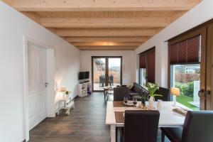 a living room with a table and chairs and a couch at Ferienwohnung Tiefenbach in Hürtgenwald