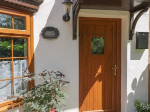 Willow Cottage في Watton: باب منزل بجانبه محطة