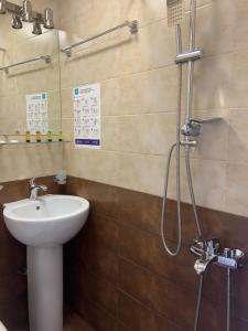 a bathroom with a sink and a shower at Sweet Rooms Inn in Tbilisi City