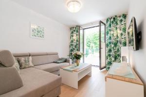 a living room with a couch and a table at Apartament Garden z ogródkiem - Dream Apart in Ustroń