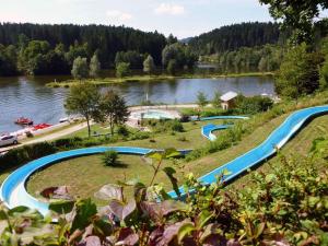 a group of pools on a hill next to a river at Ferienwohnung Pension Hauer Hof in Wegscheid