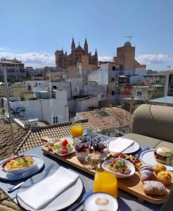 a table with plates of food on top of a building at Puro Hotel Oasis Urbano in Palma de Mallorca