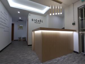 a lobby with a reception desk in a building at Signel Hostel in Kota Kinabalu