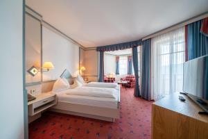 Postel nebo postele na pokoji v ubytování Hotel Alexanderhof