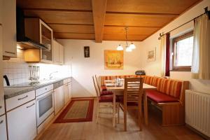 a kitchen with a table and chairs in a room at Almliesl PIES-458 in Piesendorf