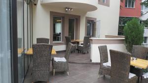 un patio avec des chaises, des tables et un bar dans l'établissement Hotel Dream, à Stara Zagora