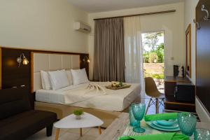 a bedroom with a bed and a living room at George Beach Studios in Pefki Rhodes