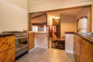 a kitchen with a table and a stove top oven at Chestnut Brae Farmstay - Chestnut Retreat in Nannup