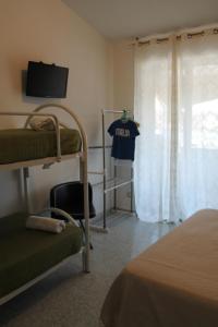 a bedroom with a bunk bed with a t shirt on a window at VesuView Guest House near the Ruins in Pompei