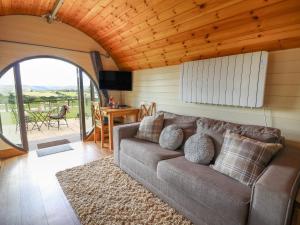 a living room with a couch and a view of a patio at Valley View in Rhayader