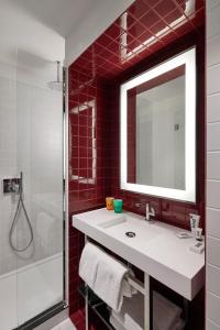 a bathroom with a sink and a mirror at Mama Shelter Luxembourg in Luxembourg