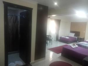 Postel nebo postele na pokoji v ubytování Amin Hotel