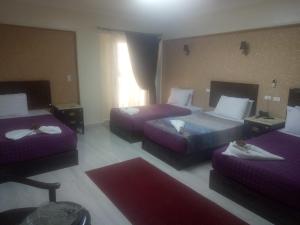 Postel nebo postele na pokoji v ubytování Amin Hotel