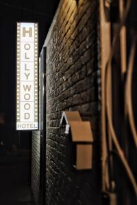 a hotel sign on the side of a brick wall at Hotel Hollywood in Lazarevskoye