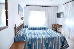Posteľ alebo postele v izbe v ubytovaní Hotel Maruxa