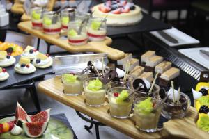 a bunch of appetizers and desserts on a table at Copthorne Downtown by Millennium in Abu Dhabi