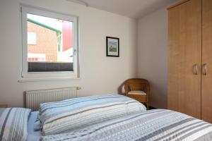 Postel nebo postele na pokoji v ubytování De Kanalkieker Apartmenthaus Meier