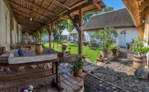 an outdoor patio with a table and potted plants at Penzion Pastuška in Brod nad Dyjí