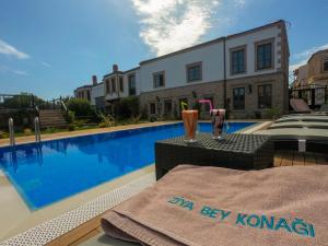 a villa with a swimming pool in front of a building at Ziyabey Konagi in Ayvalık +19 photos