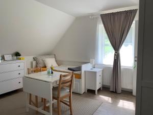 a living room with a table and a bed and a window at Steira-Studios in Ehrenhausen