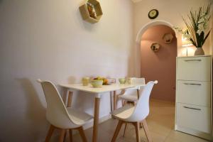 a kitchen with a table and chairs and a refrigerator at Nasia's house in Agios Rokkos