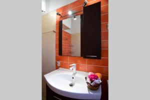 a bathroom with a sink and a mirror at Nasia's house in Agios Rokkos +13 photos