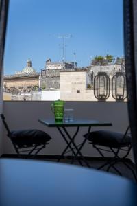 a table and chairs on a balcony with a view at Arco Vecchio Urban Suite - Epoca Collection in Lecce
