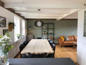 a dining room with a wooden table and chairs at Traditional Faroese house in Tórshavns city center in Tórshavn