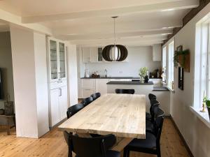 a kitchen and dining room with a wooden table and chairs at Traditional Faroese house in Tórshavns city center in Tórshavn +30 photos