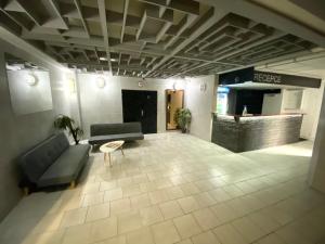 a lobby with a couch and a table in a building at Hotel Koldum in Litvínov