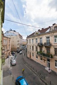 a view of a city street with cars and buildings at Avangard DeLuxe Art Apart in Lviv