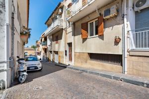 a car parked on a street next to buildings at Tra il Centro e il Mare Apartment con terrazzo in Aci Castello