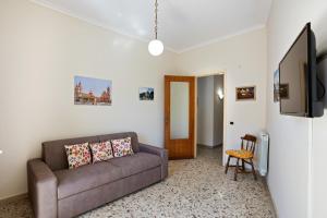 a living room with a couch and a tv at Tra il Centro e il Mare Apartment con terrazzo in Aci Castello